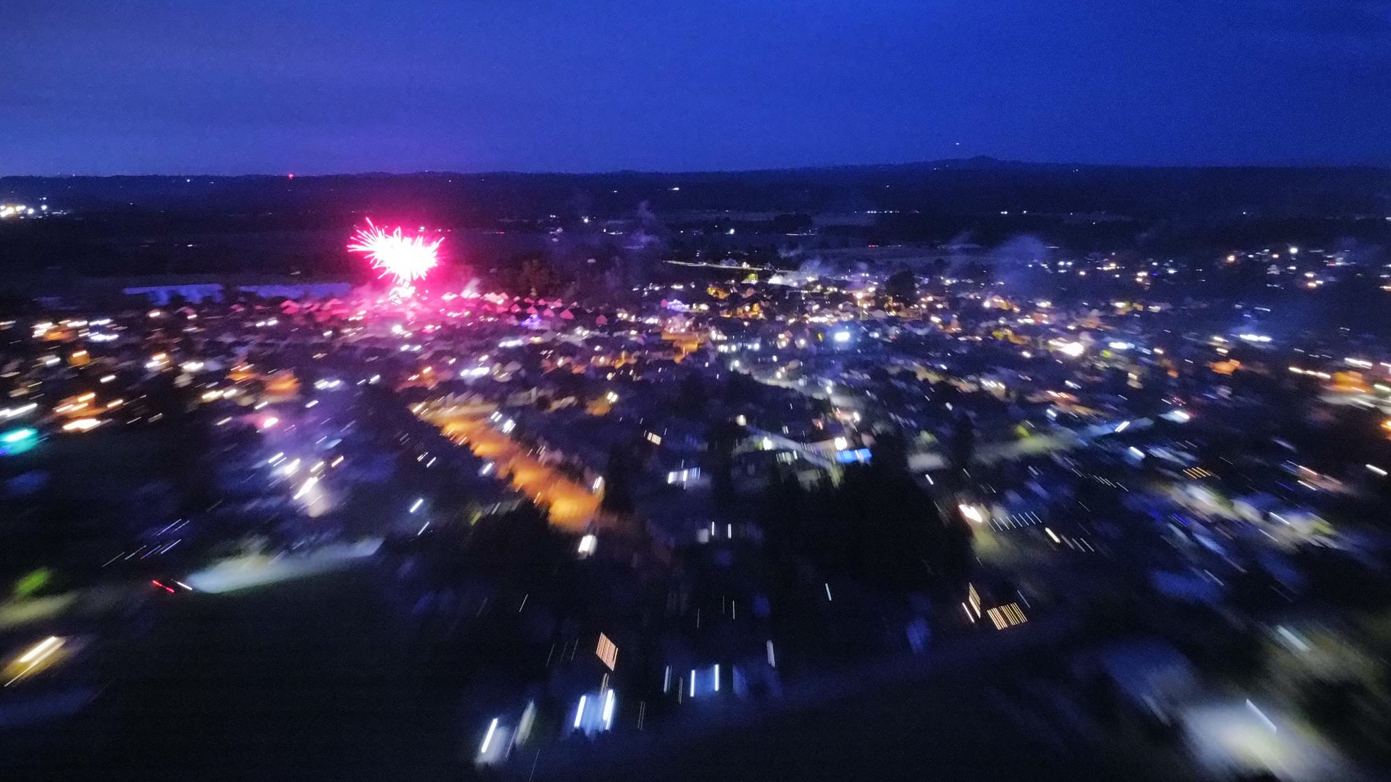 a long exposure smeared by movement, where the camera drifted and every light became a streak