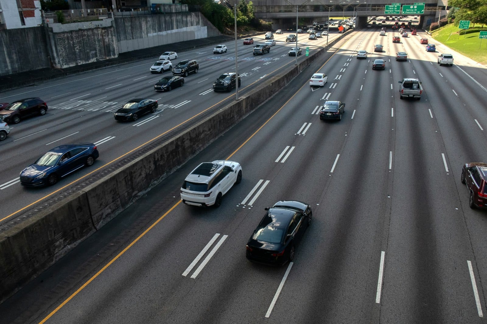 Cars spread across many lanes of a highway, seen from an overpass