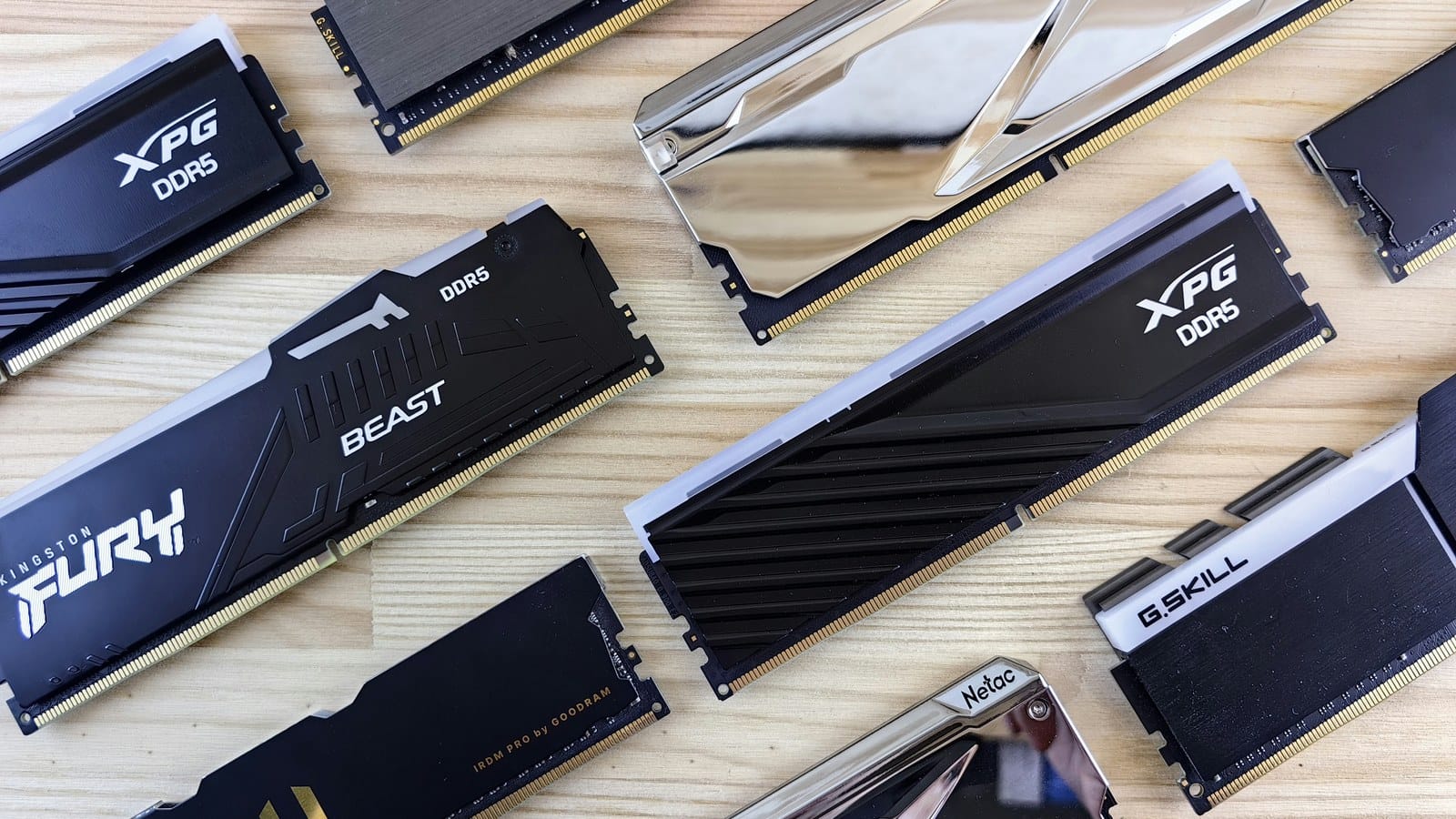 A dozen memory sticks from several brands laid out on a wooden table