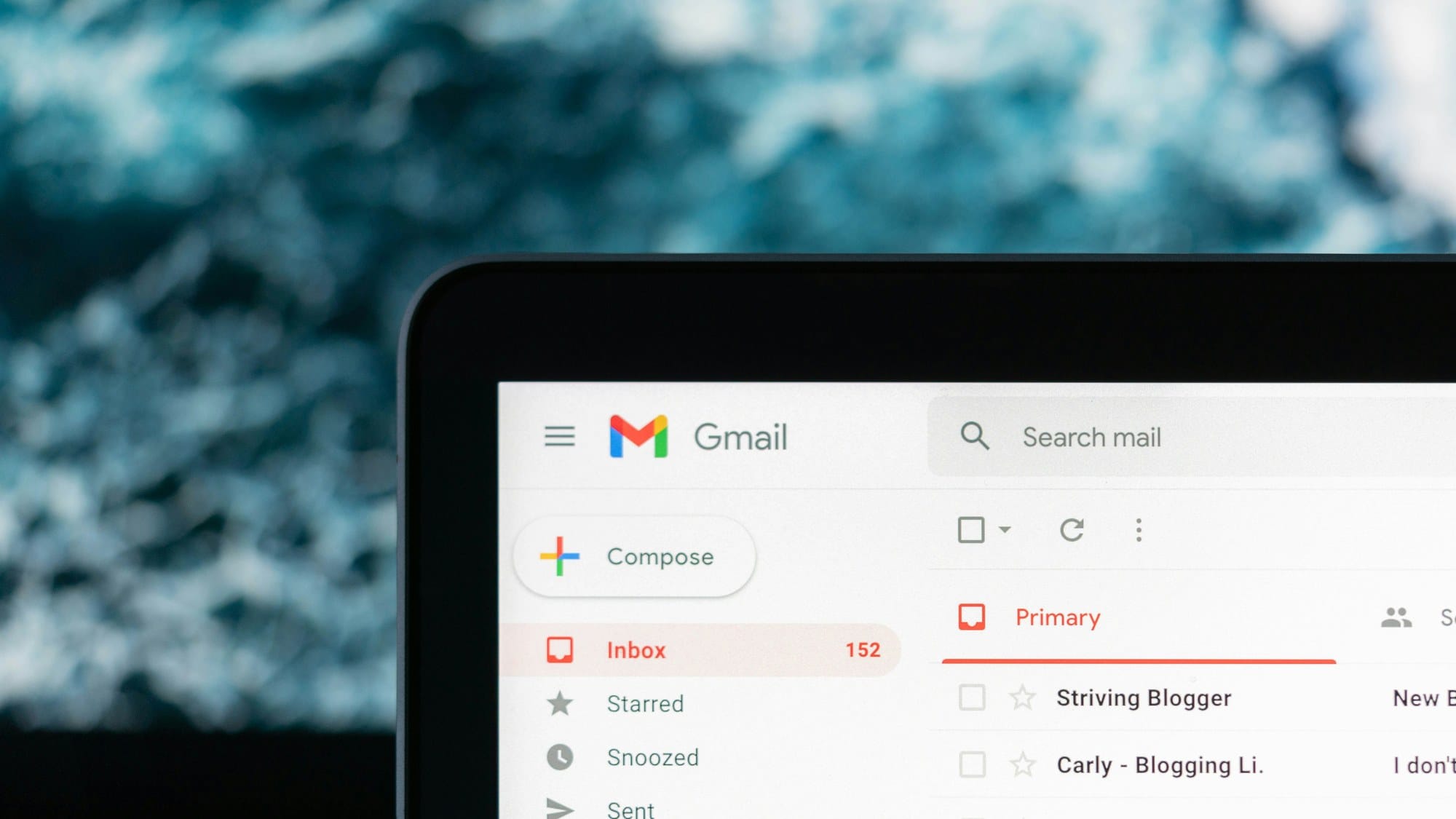 A laptop screen showing a Gmail inbox with 152 unread messages