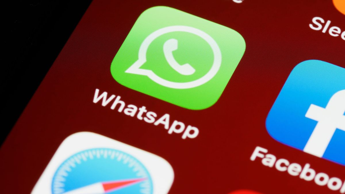 The WhatsApp app icon next to Facebook on a phone home screen