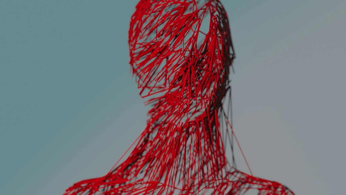 A human figure formed from thousands of scattered red line fragments against a pale blue sky