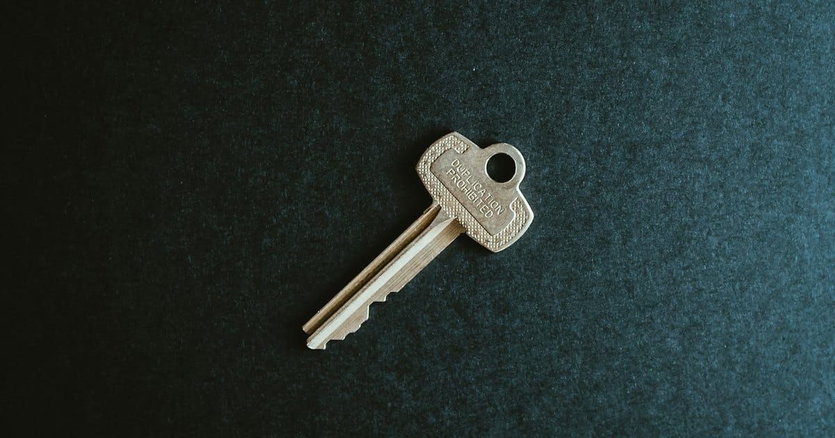 A single key on dark felt. Photo by Kelly Sikkema on Unsplash.