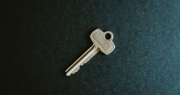 A single key on dark felt. Photo by Kelly Sikkema on Unsplash.