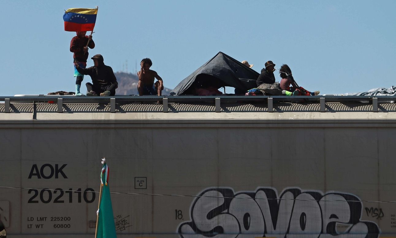 Migrants with a Venezuelan flag on a train in Chihuahua, Mexico. Photo: Luis Torres/EPA