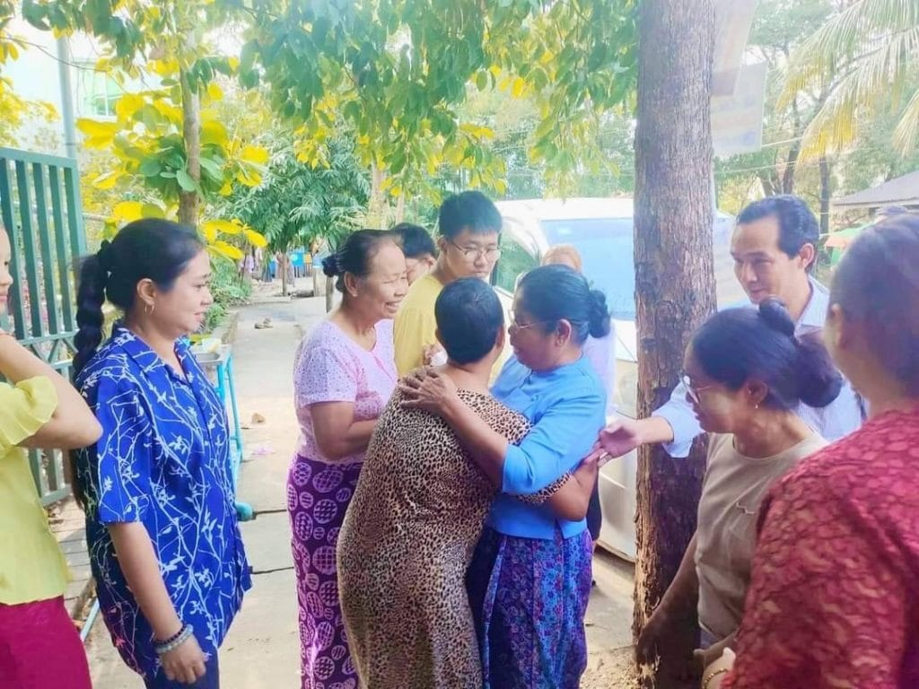 One of the newly freed prisoners is welcomed by family members after her release. Photo via The Irrawaddy