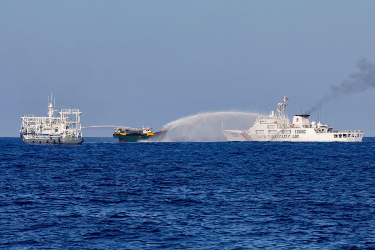 A March 2024 file photo of Chinese Coast Guard vessels firing water cannons towards a Philippine vessel near Second Thomas Shoal. Photo: Adrian Portugal/Reuters