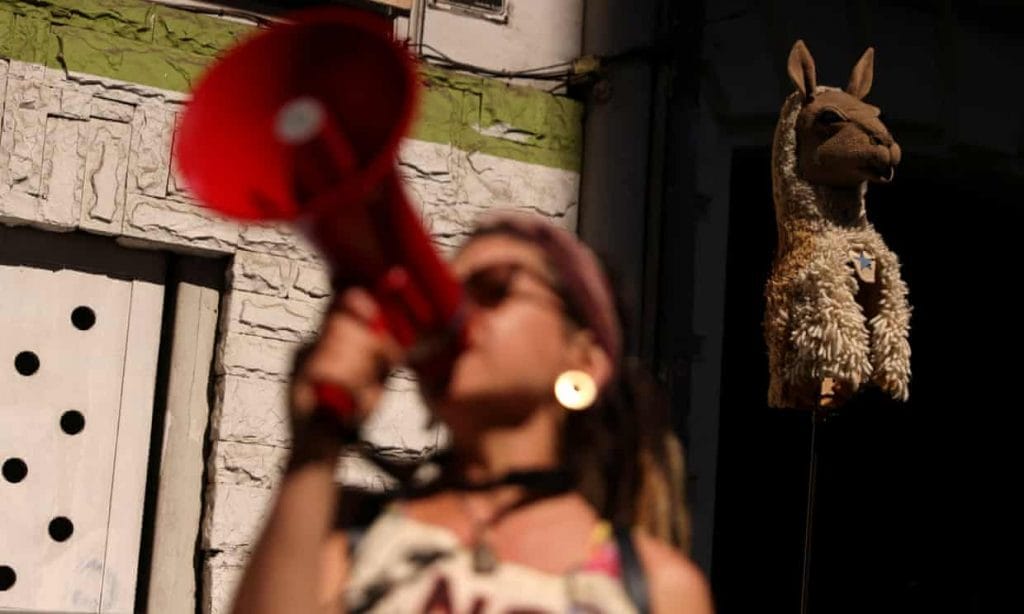 An environmental activist protests the Dominga copper and iron mining project in Santiago, Chile.&nbsp;Photo: Iván Alvarado/Reuters
