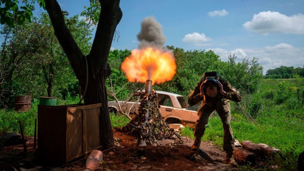 A Ukrainian soldier fires a mortar at Russian positions. Photo: Efrem Lukatsky/AP via FT