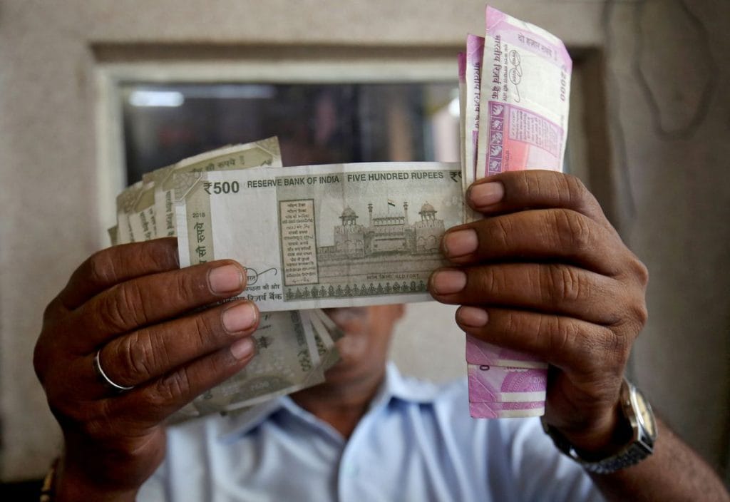 A cashier checks Indian rupee notes. Photo: Reuters/Amit Dave