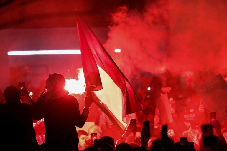A flare burns during a protest in support of Palestinians in Gaza, near the Israeli embassy in Amman, Jordan. Photo: Alaa Al-Sukhni/Reuters