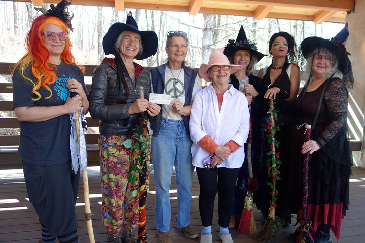 Floyd's Mystical Witches gift funds to June Bug Center, Floyd Friends of Asylum Seekers