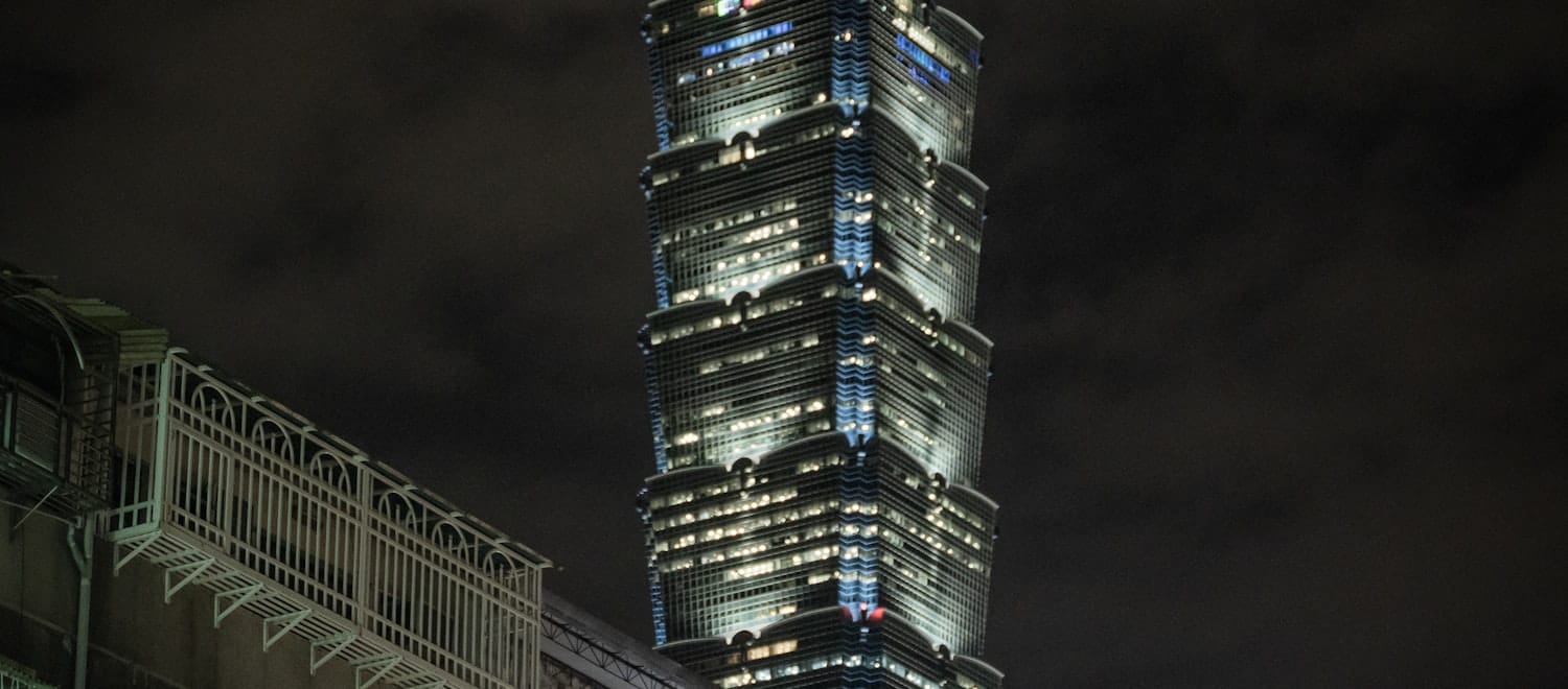 Taipei 101 at night — Taiwan's grid is the world's most legible 'megawatt is the scarce asset' case
