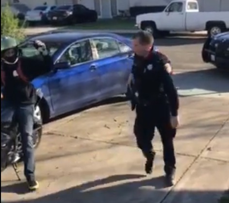 Officer David McLaughlin holsters his gun