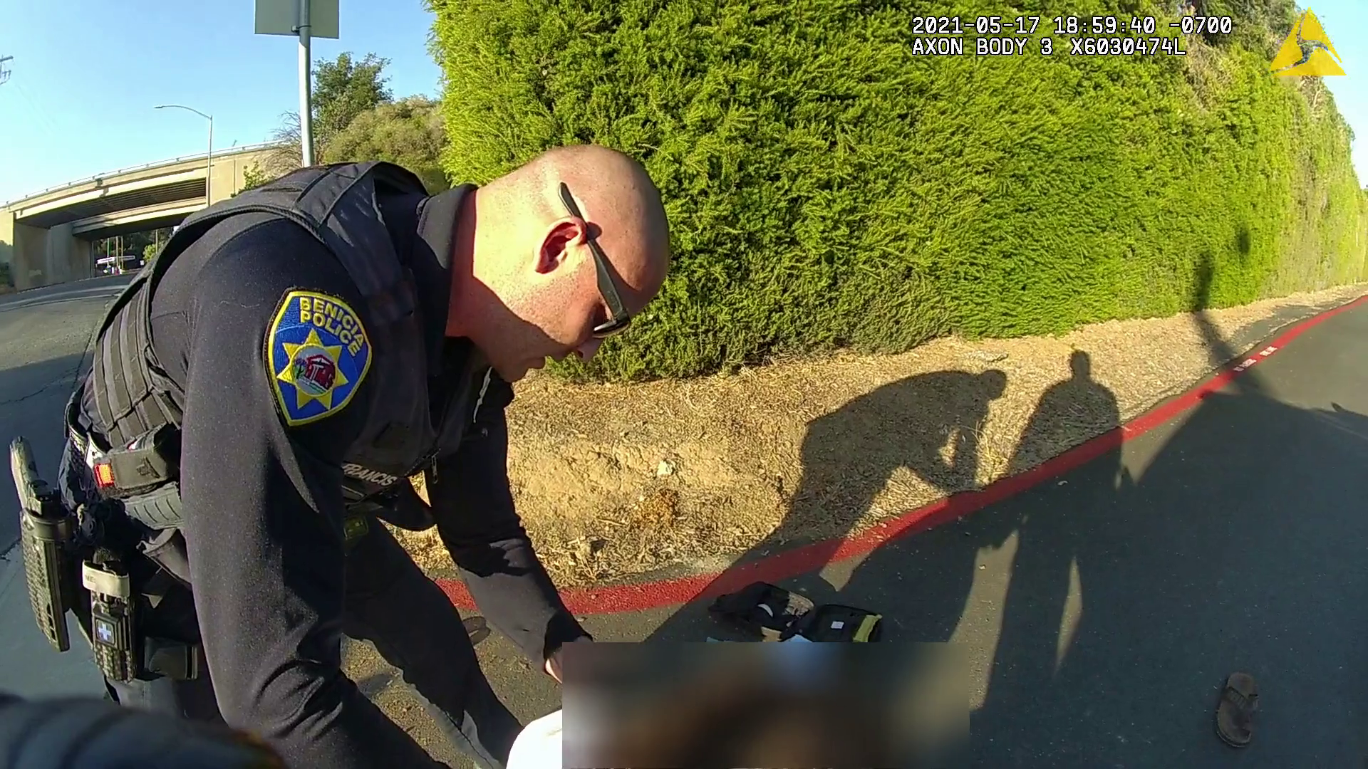 Officer Christopher Francis attempts to stop the bleeding from Gary Gregory's neck.