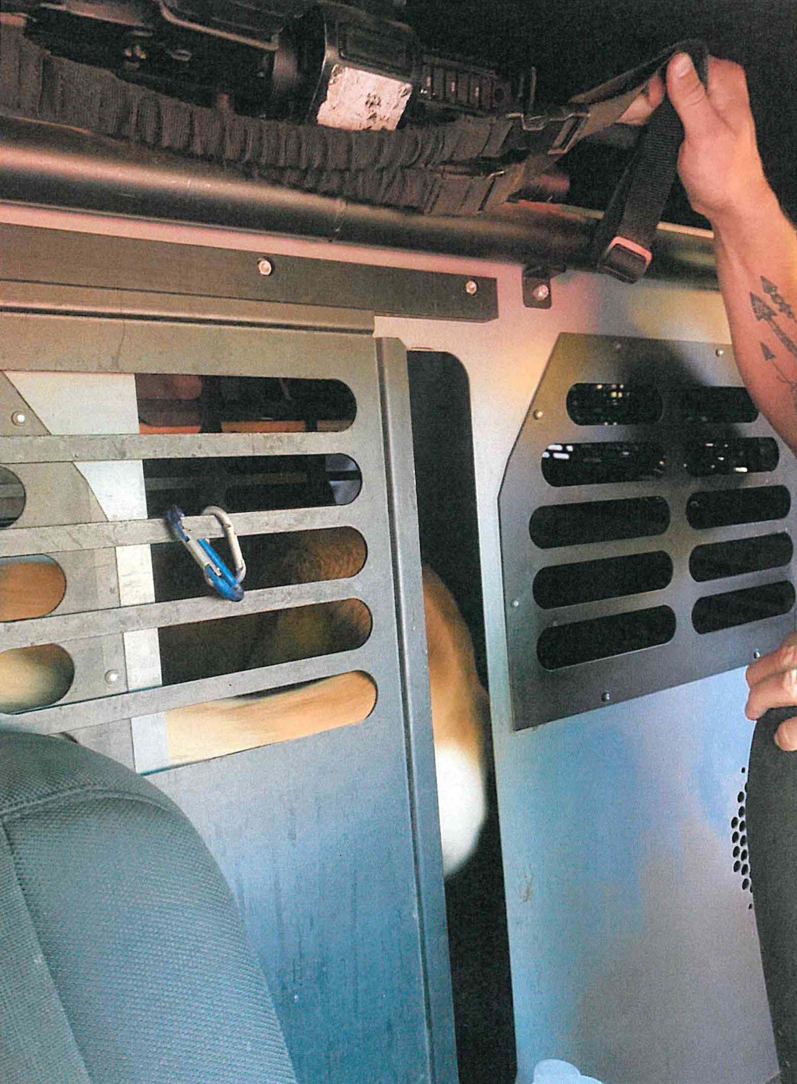 A hatch in Officer Christopher Francis's patrol car that he said he left partly open.