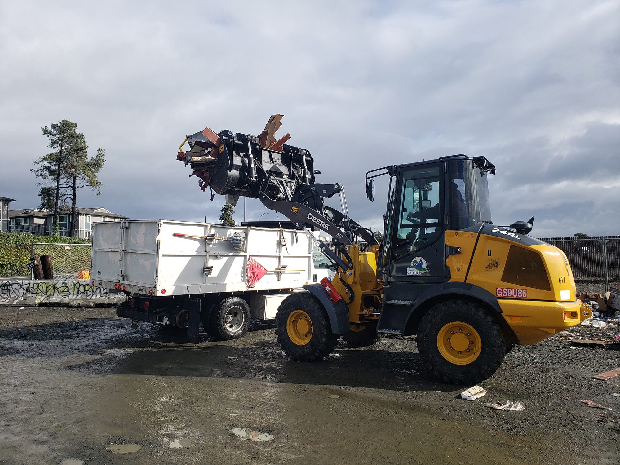 City workers clear trash at a homeless encampment at the Vallejo boat launch.