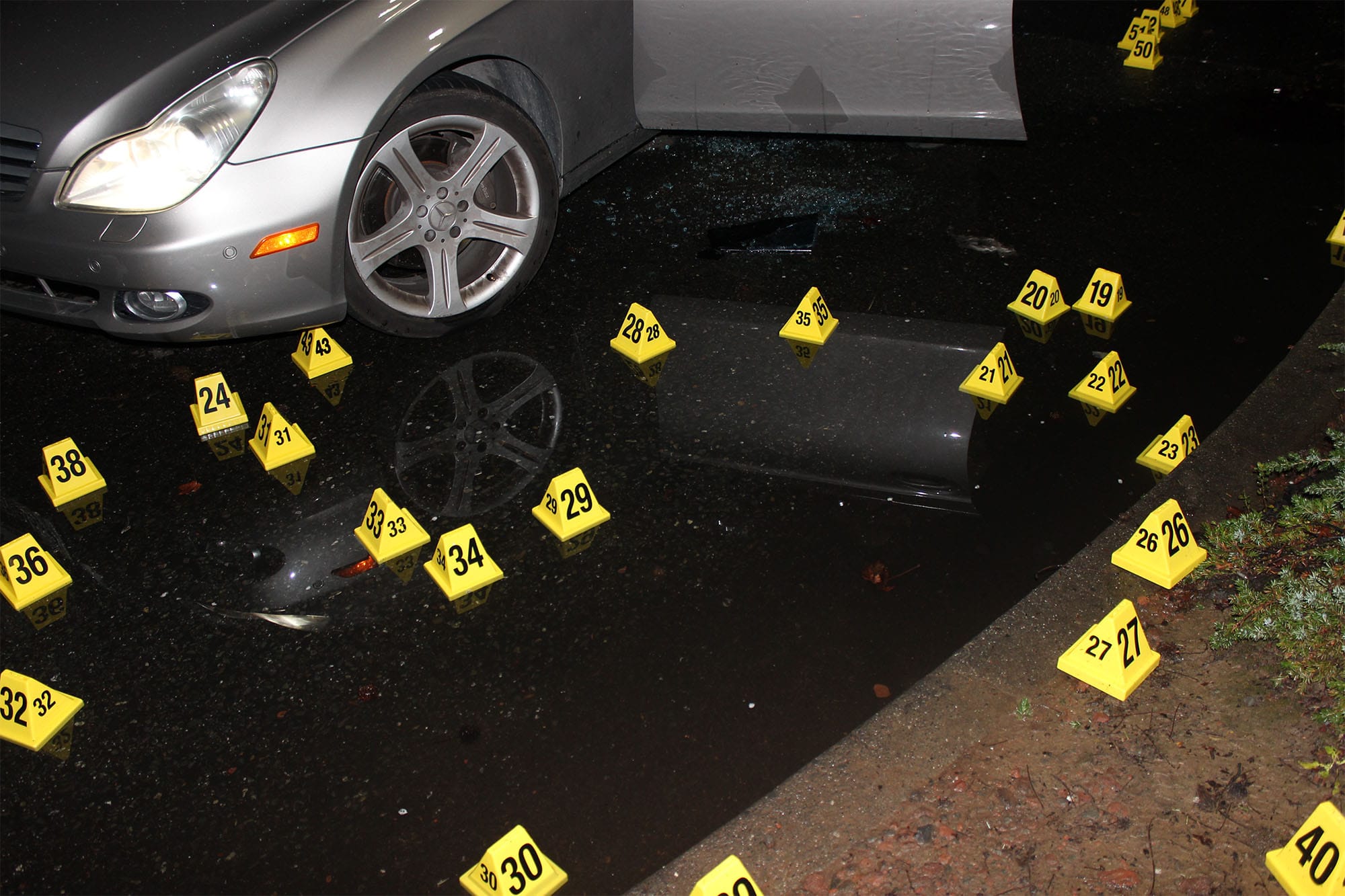 Evidence placards at the scene of the 2019 shooting of Willie McCoy, who was shot 55 times by six officers.