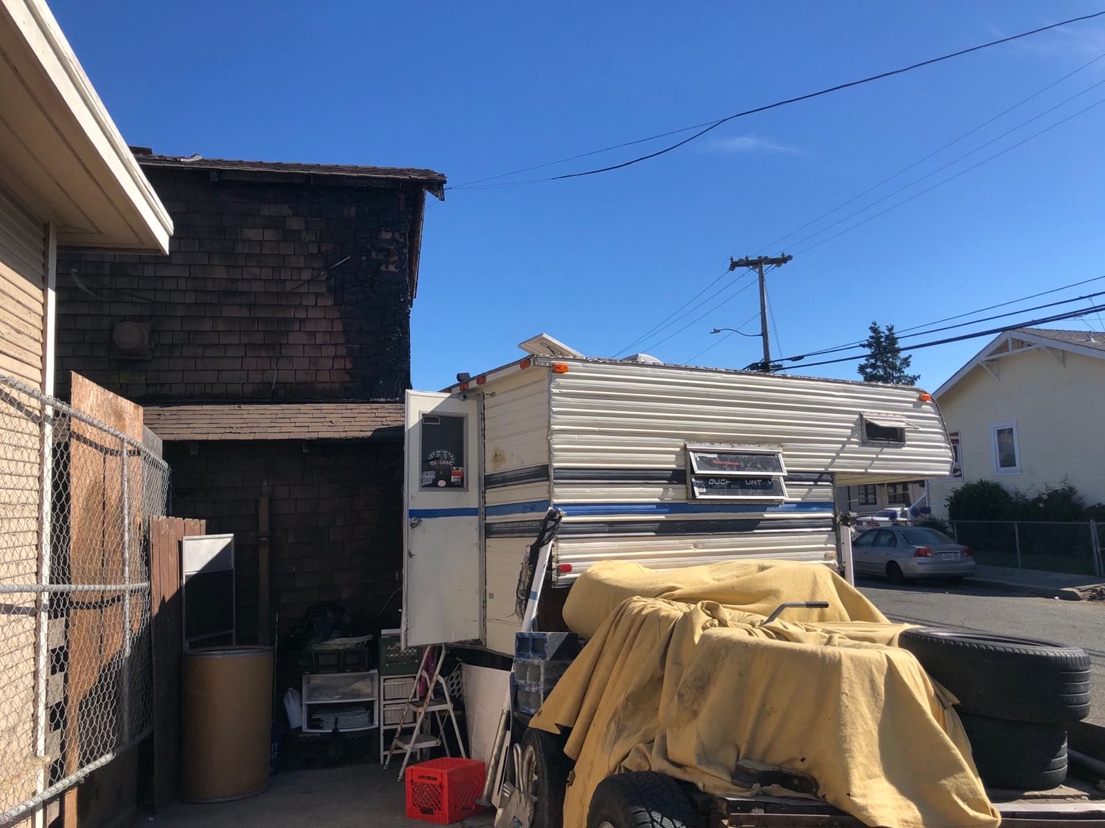 A camper next to a burned home on Illinois Street 