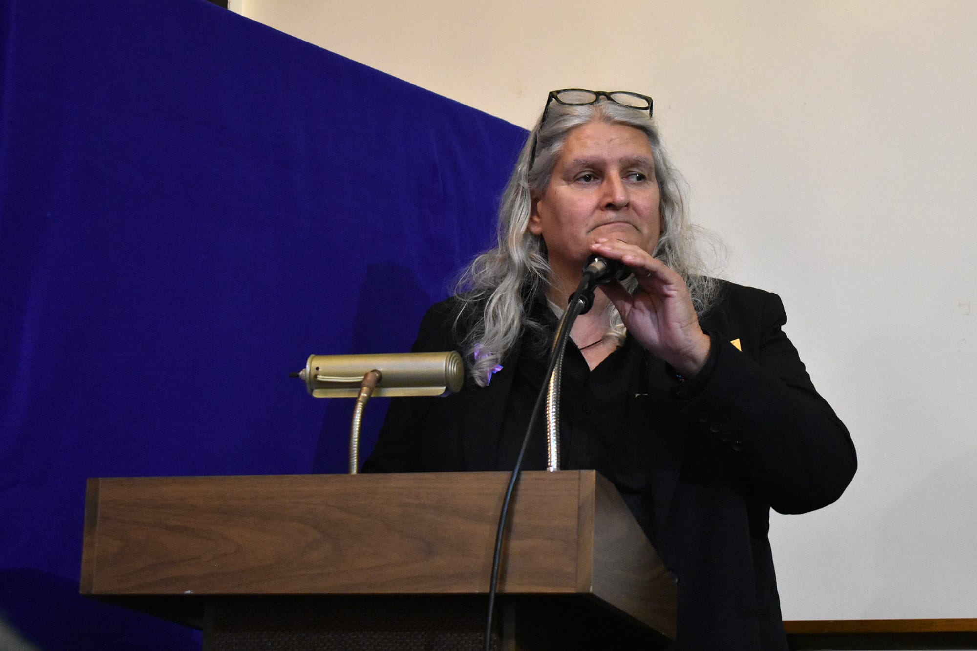 Jeriann Guzman reads the names of those who have died during the Nov. 22 vigil. 