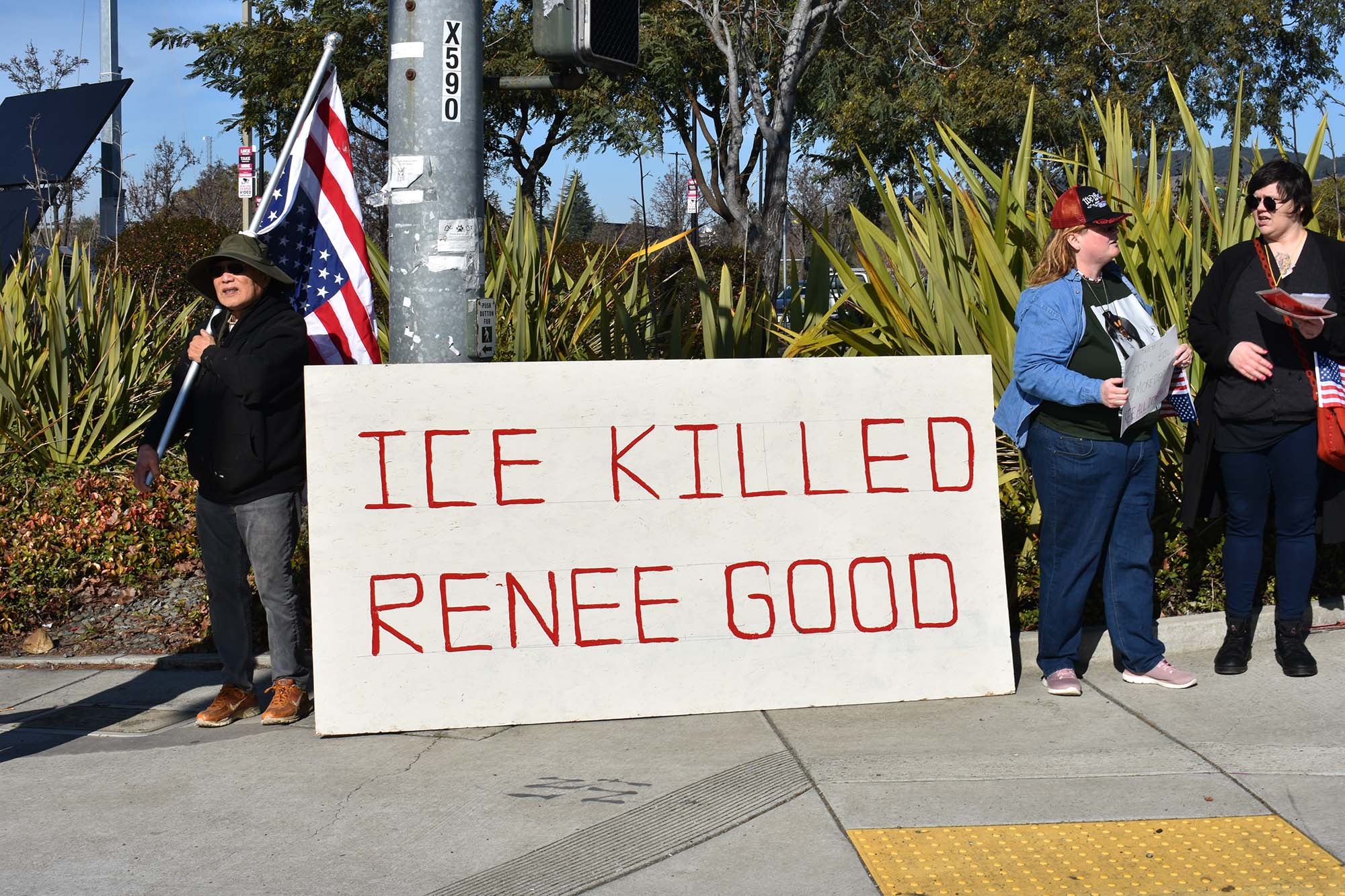 D.L. Lang stands to the right of a sign at the Vallejo protest. Photo: Gretchen Smail.