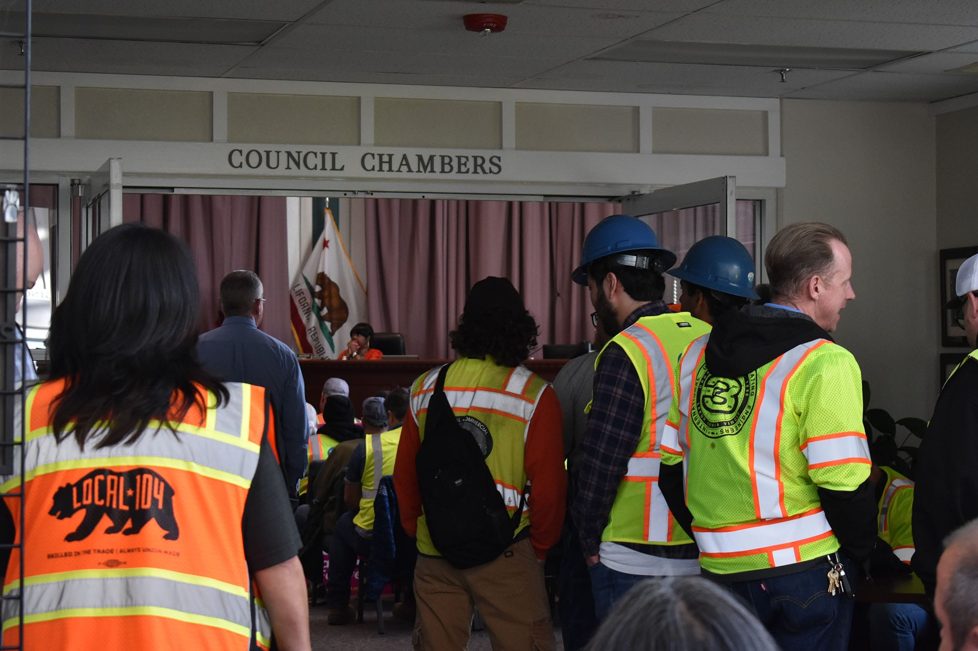 Union workers fill the rotunda outside the council chambers at the April 21 meeting. 