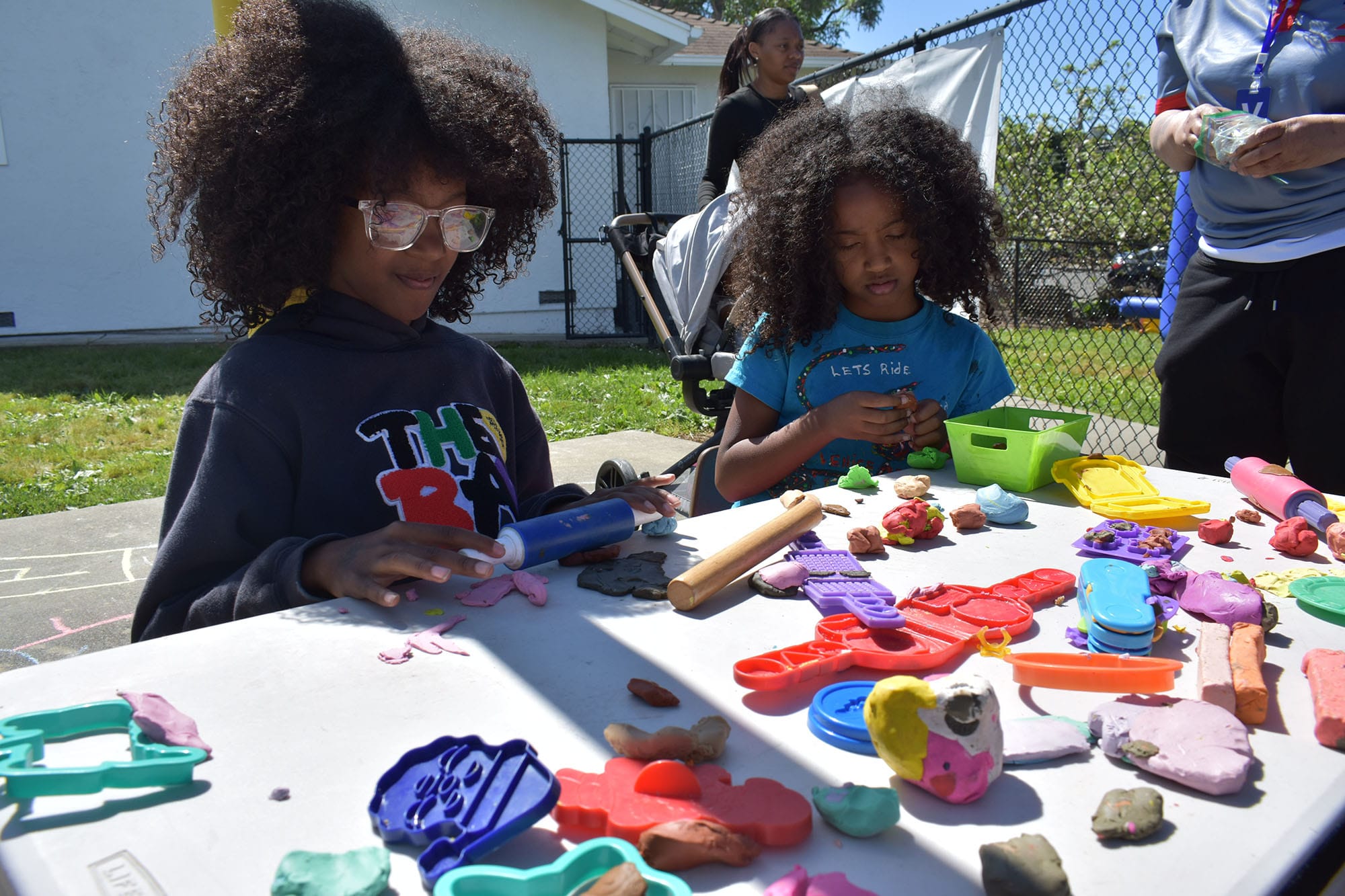 Sira Winston at the clay table at Emmanuel Temple’s Parking Lot Play.