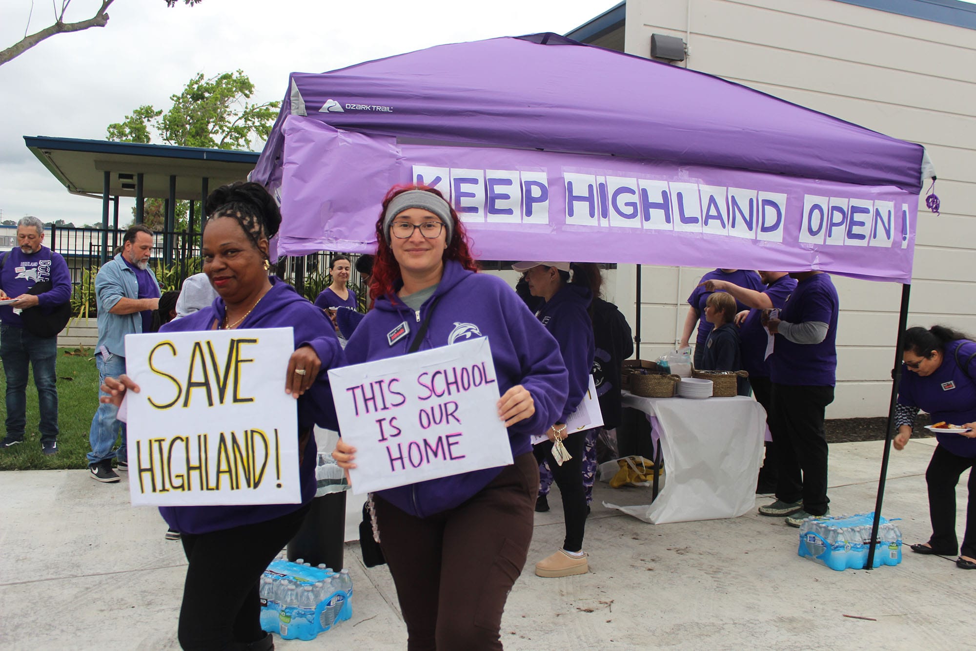 Tiffini Hardy and Tanea Fukushima rally outside a school board meeting to stop Highland Elementary School from closing. 