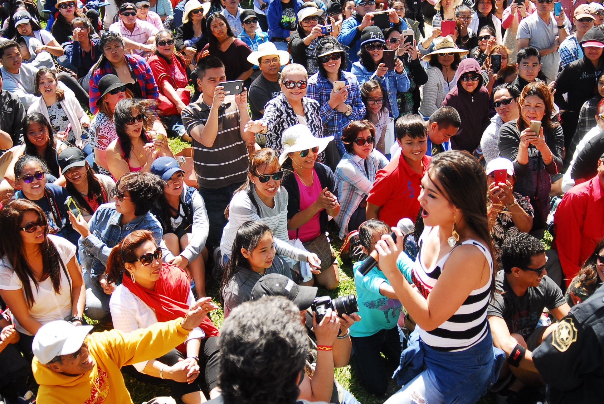 Audiences listen to a Filipina singer at Pista Sa Nayon. 