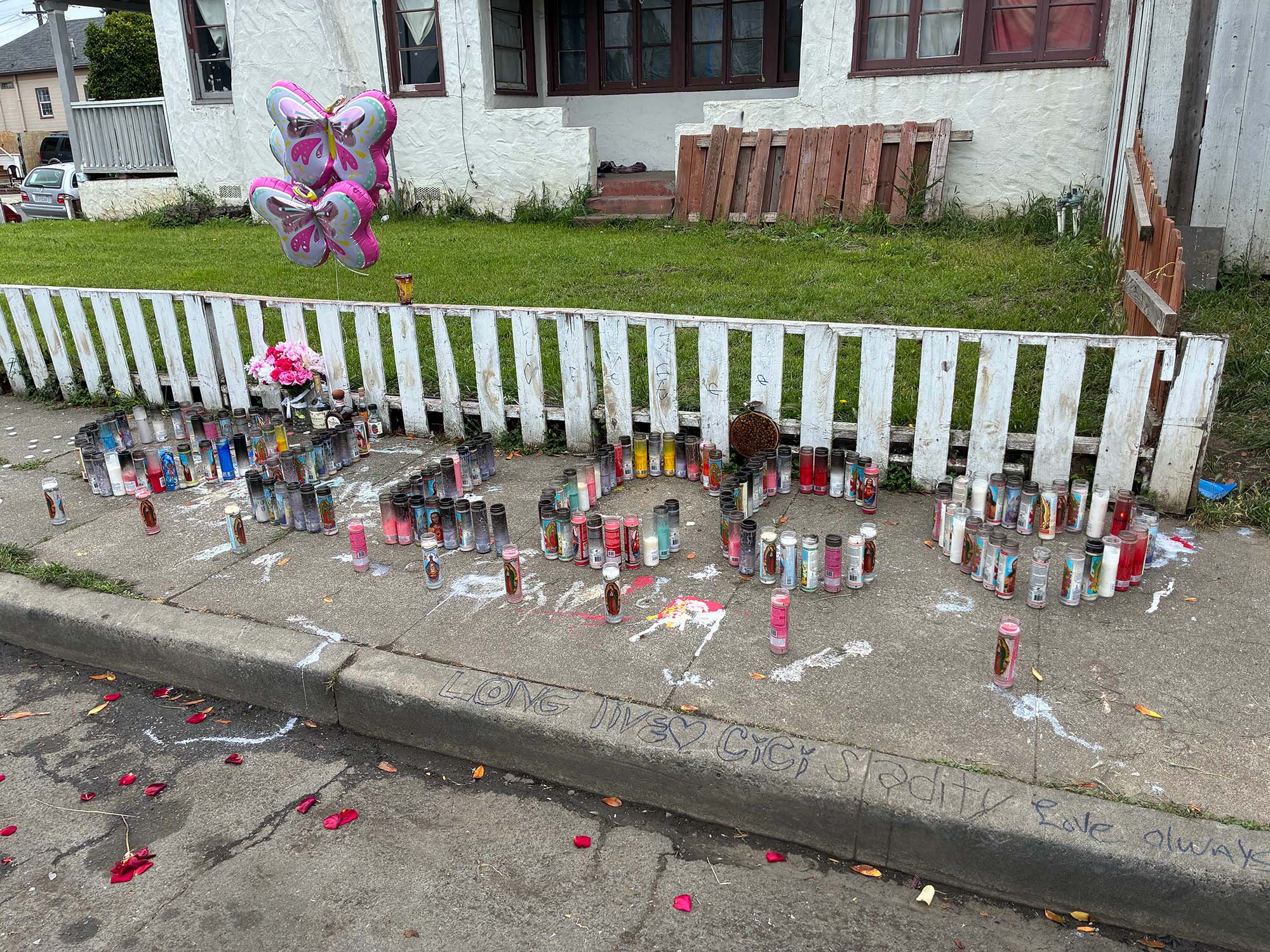 A memorial for Cici Corsetti where she was murdered, where candles spell LL CC for her nickname, Lil Cici. 
