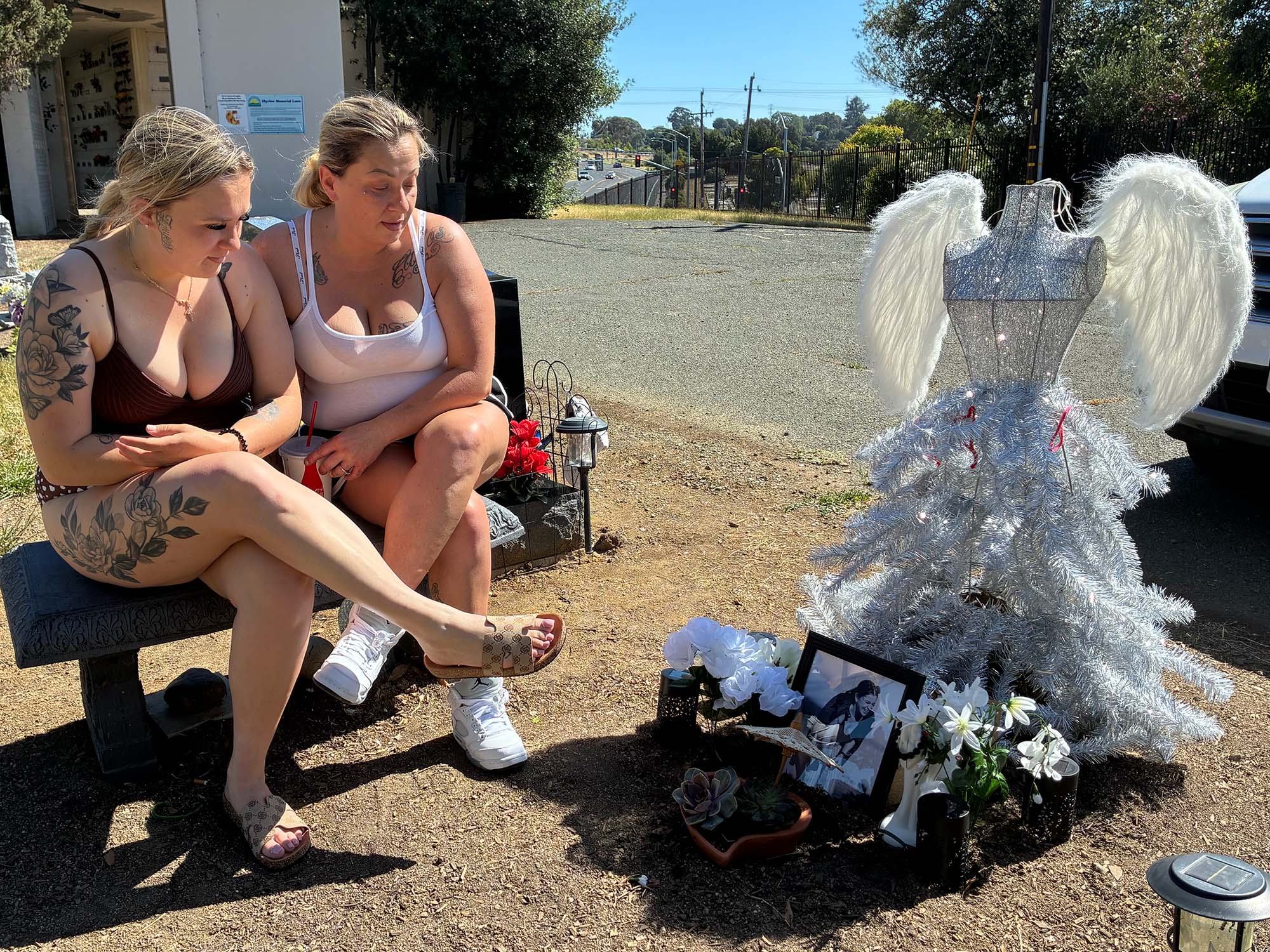 Ceicilia Corsetti's sister, Sophia Buster, left, and her mother sitting at her Vallejo gravesite. 