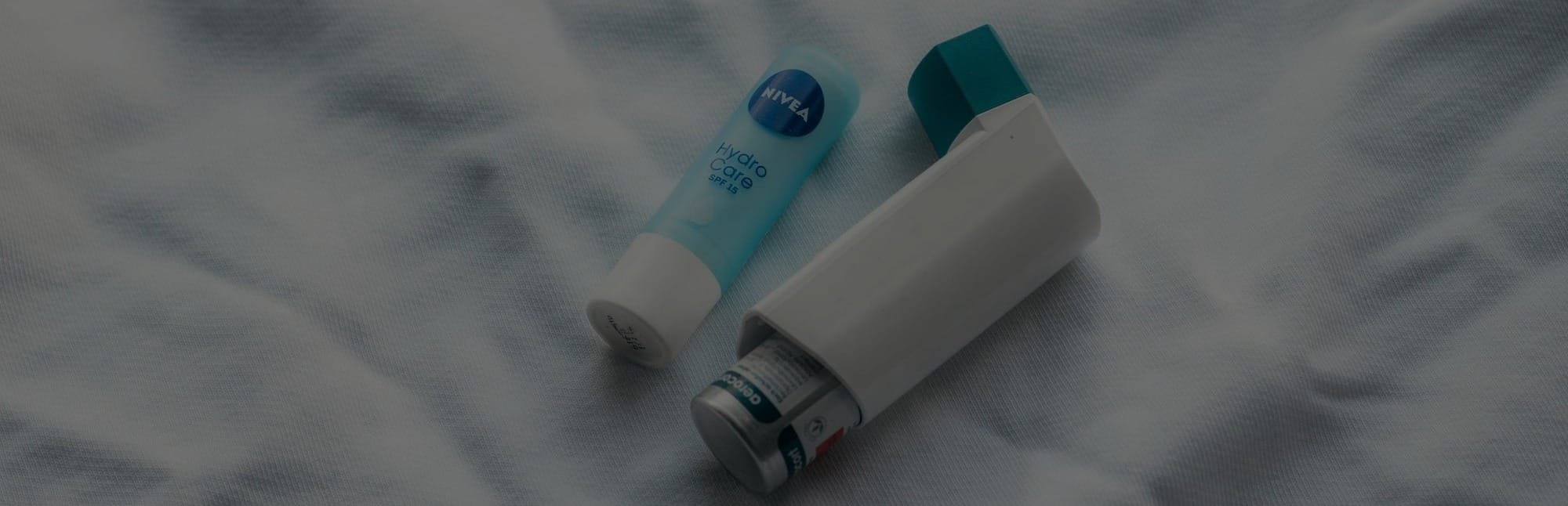 two toothbrushes sitting on top of a white sheet