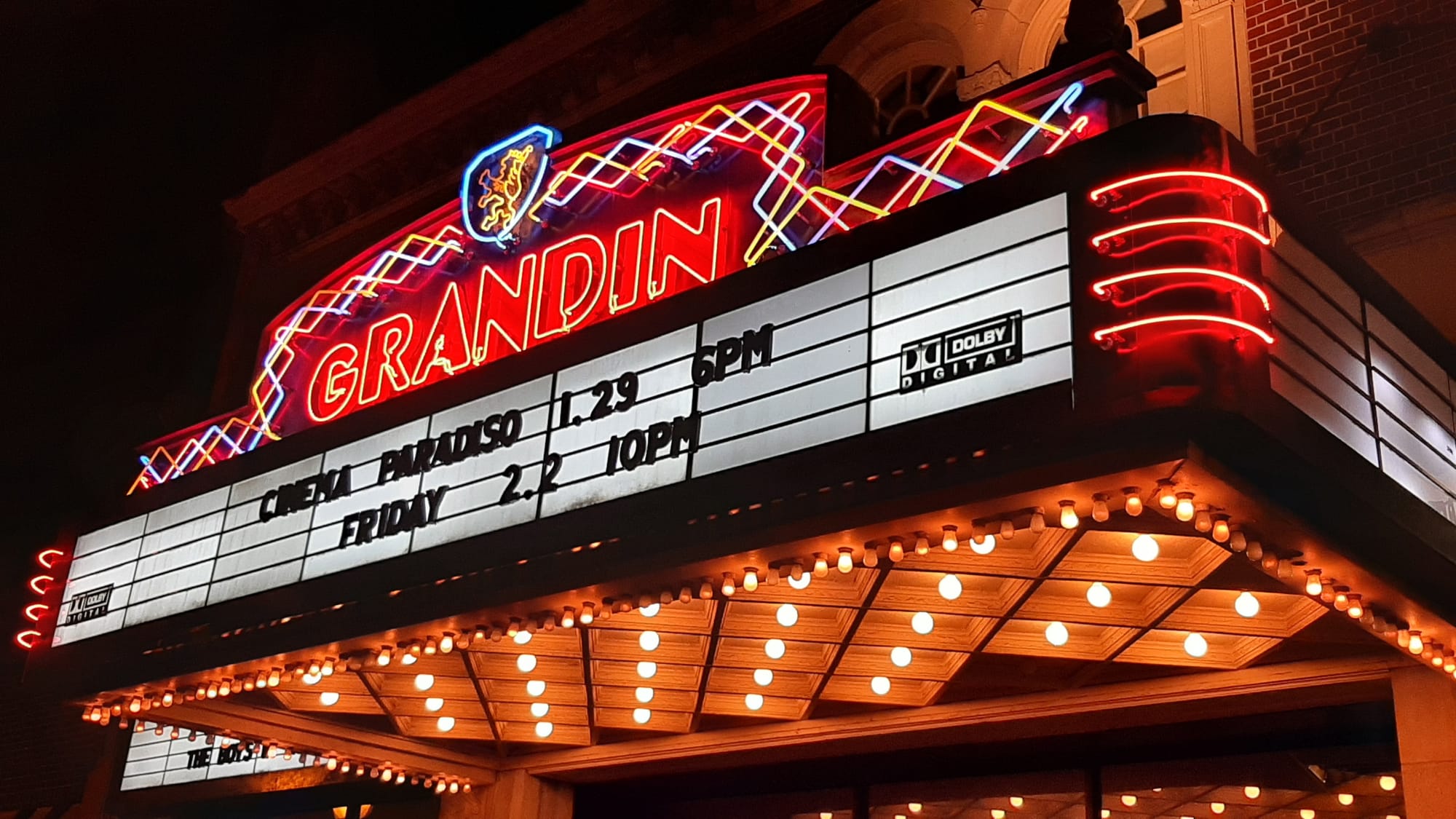 Neon light marquee for the Grandin Theater, showing Cinema Paradiso.