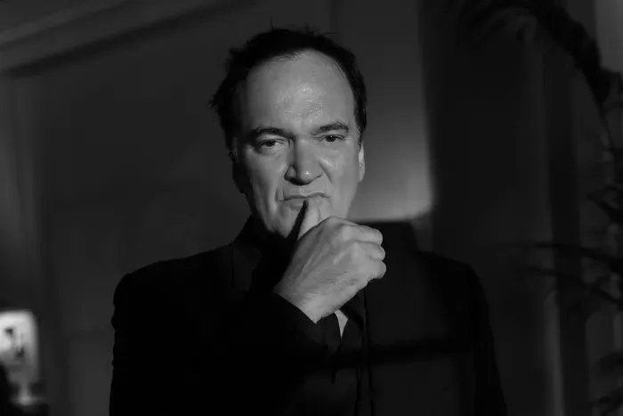Quentin Tarantino, thumbing (up) his lip