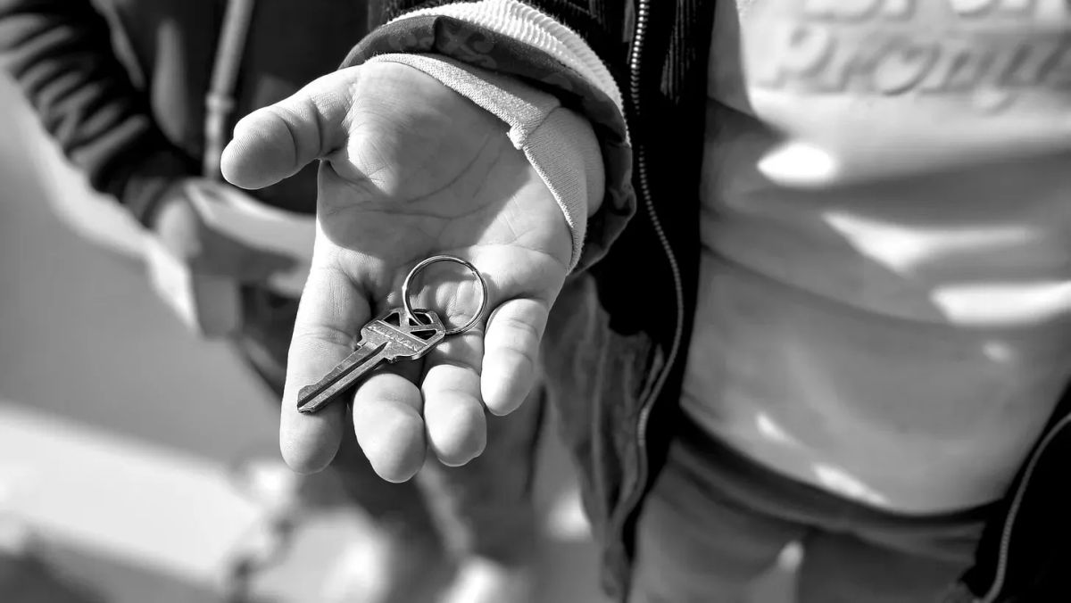 Black and white photo of a hand holding a key