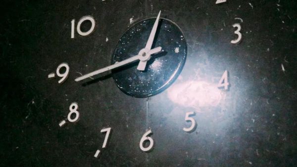 Picture of the bottom part of a clock with the 11, 12, 1 and 2 not visible. Short hand is pointing between 12 and 1 and long hand is pointed at about 43 minutes.