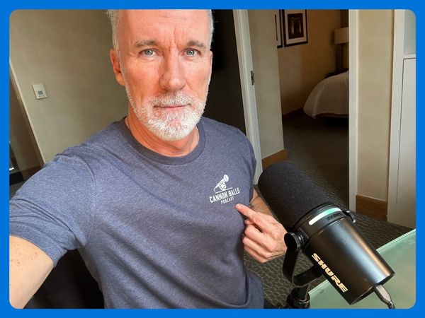 ESPN's John Buccigross wearing a Disrespected Media T-Shirt and pointing to the "Cannon Balls" logo.