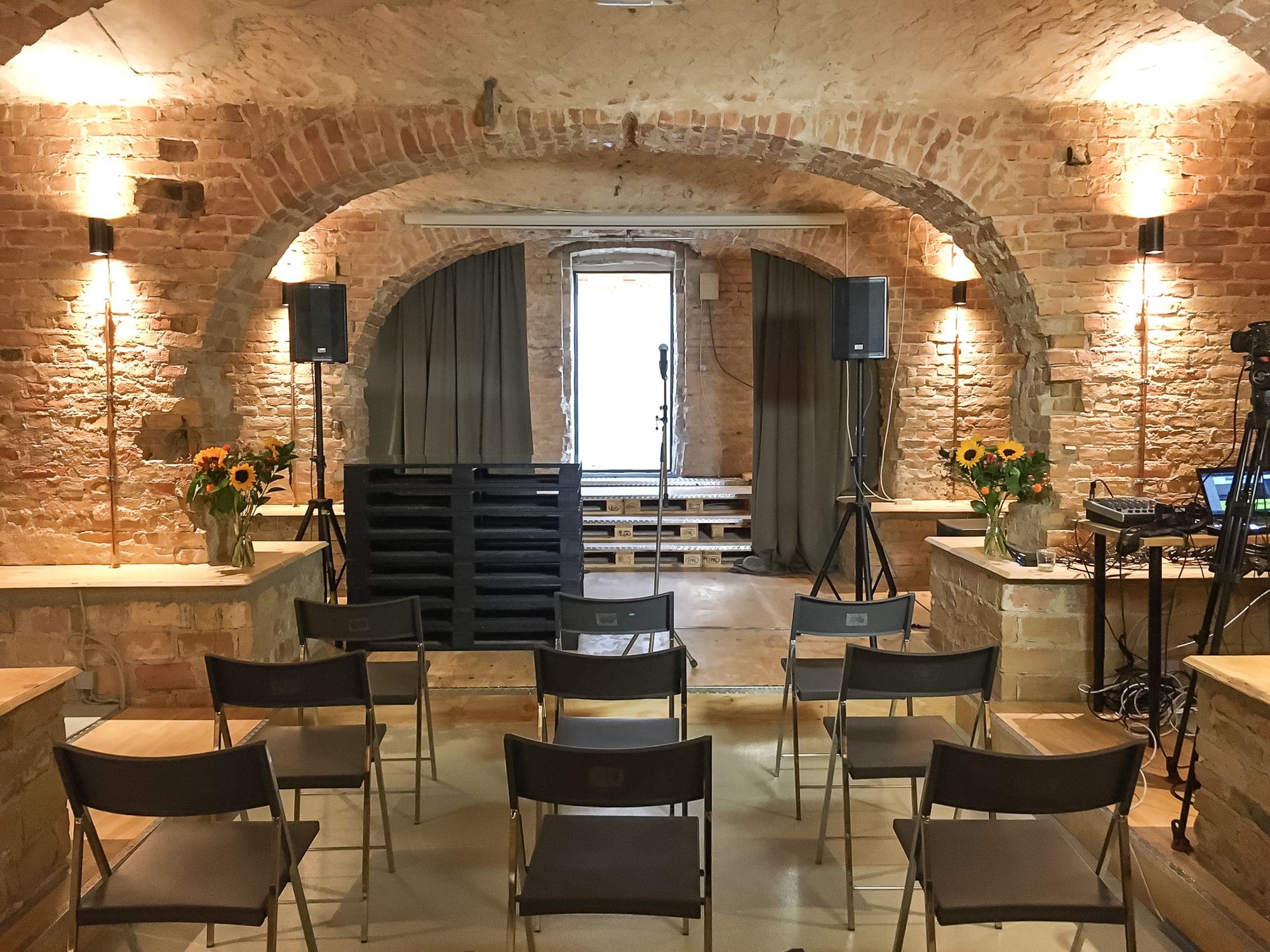 Chairs sitting in front of a stage at Engelnest coworking space in Berlin, Germany