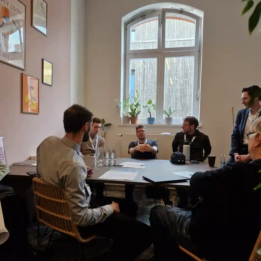 People sitting on a table and discussing ideas.