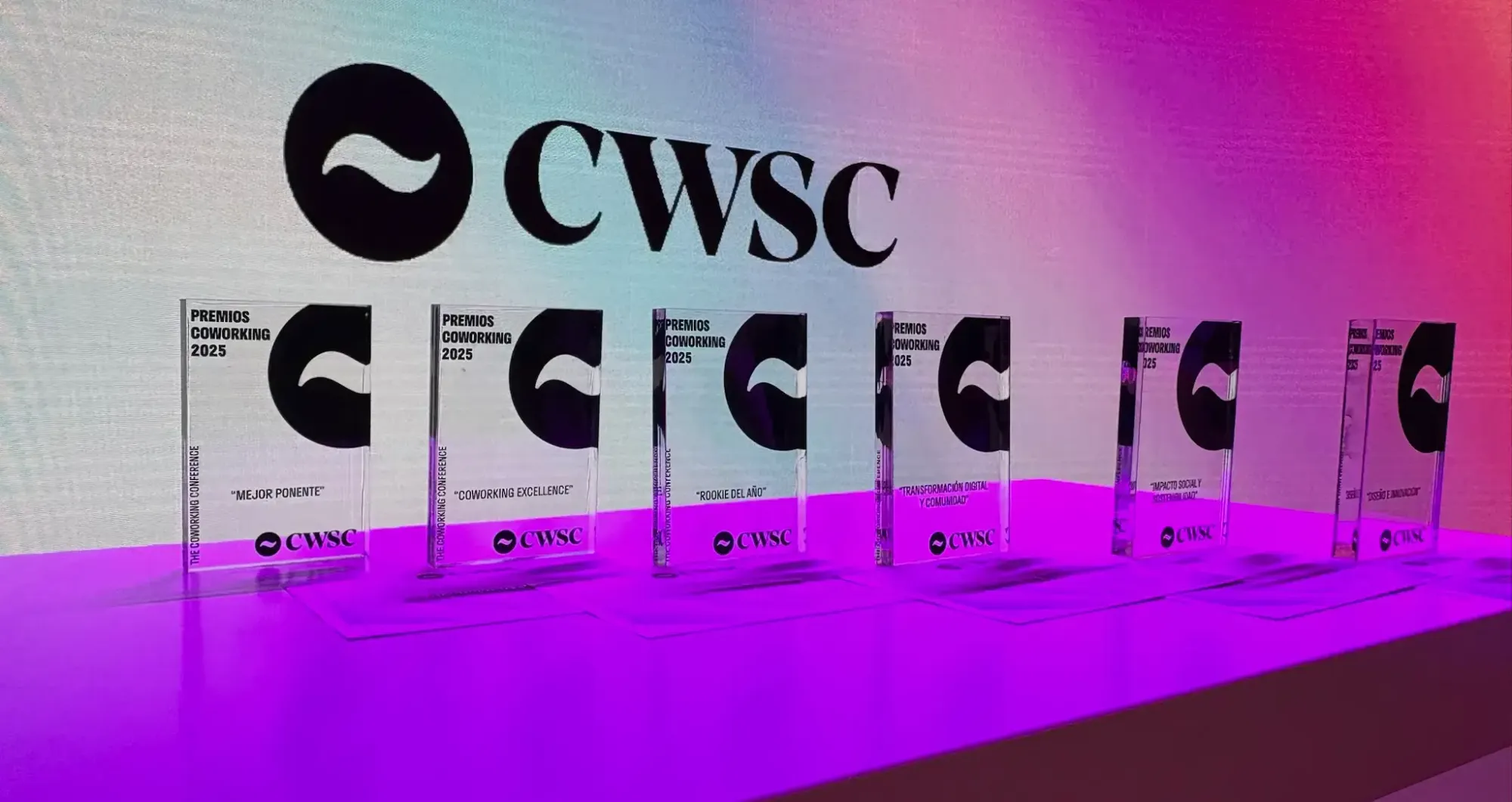 A picture of the CWSC Coworking Awards 2025 on a table with an ambient light.