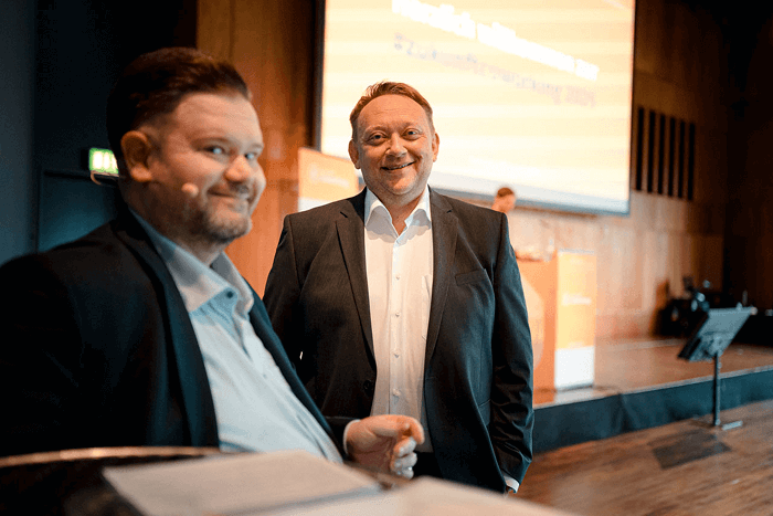 Prof. Dr. Axel Minten and Tobias Kollewe in front of the stage at #Zukunftcoworking.