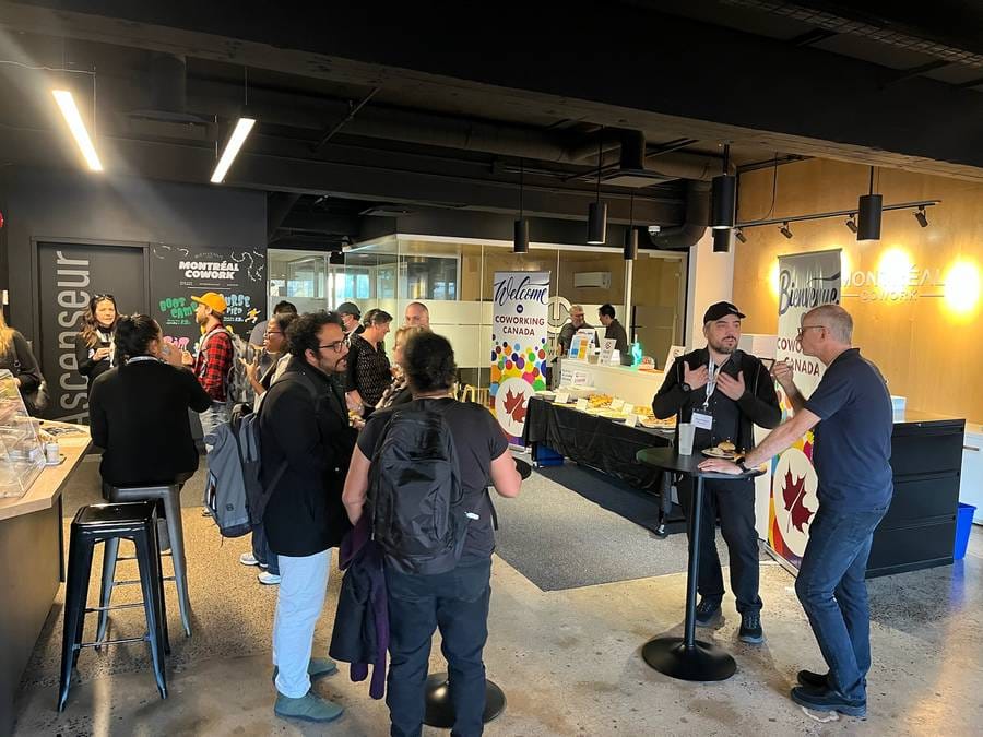 Attendees gathered at Montréal Cowork for the Coworking Canada Unconference opening reception with welcome banners
