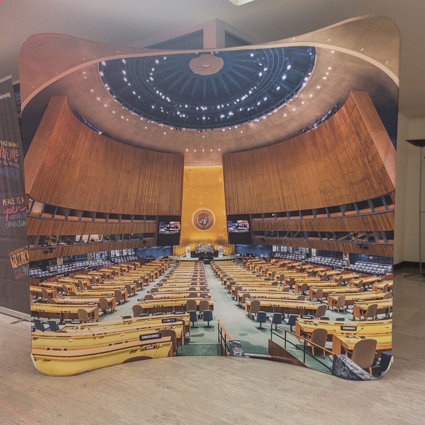 A poster in the UN shows a view of the UN general assembly space.