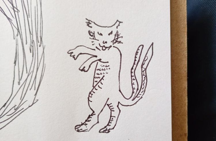 gato de pie en patas traseras. tiene dos colas. cat standing on hind legs. it has two tails.