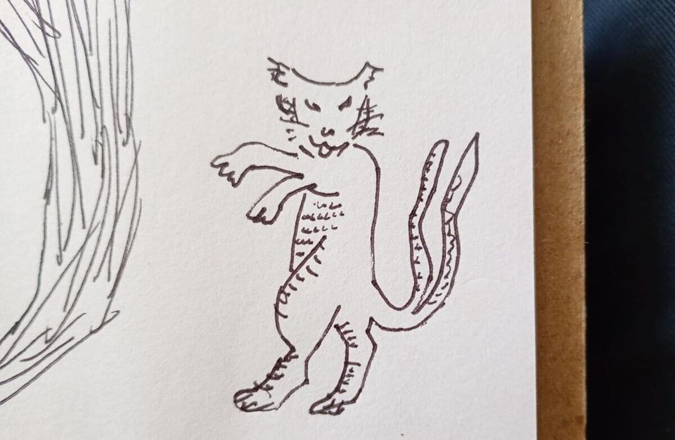 gato de pie en patas traseras. tiene dos colas. cat standing on hind legs. it has two tails.