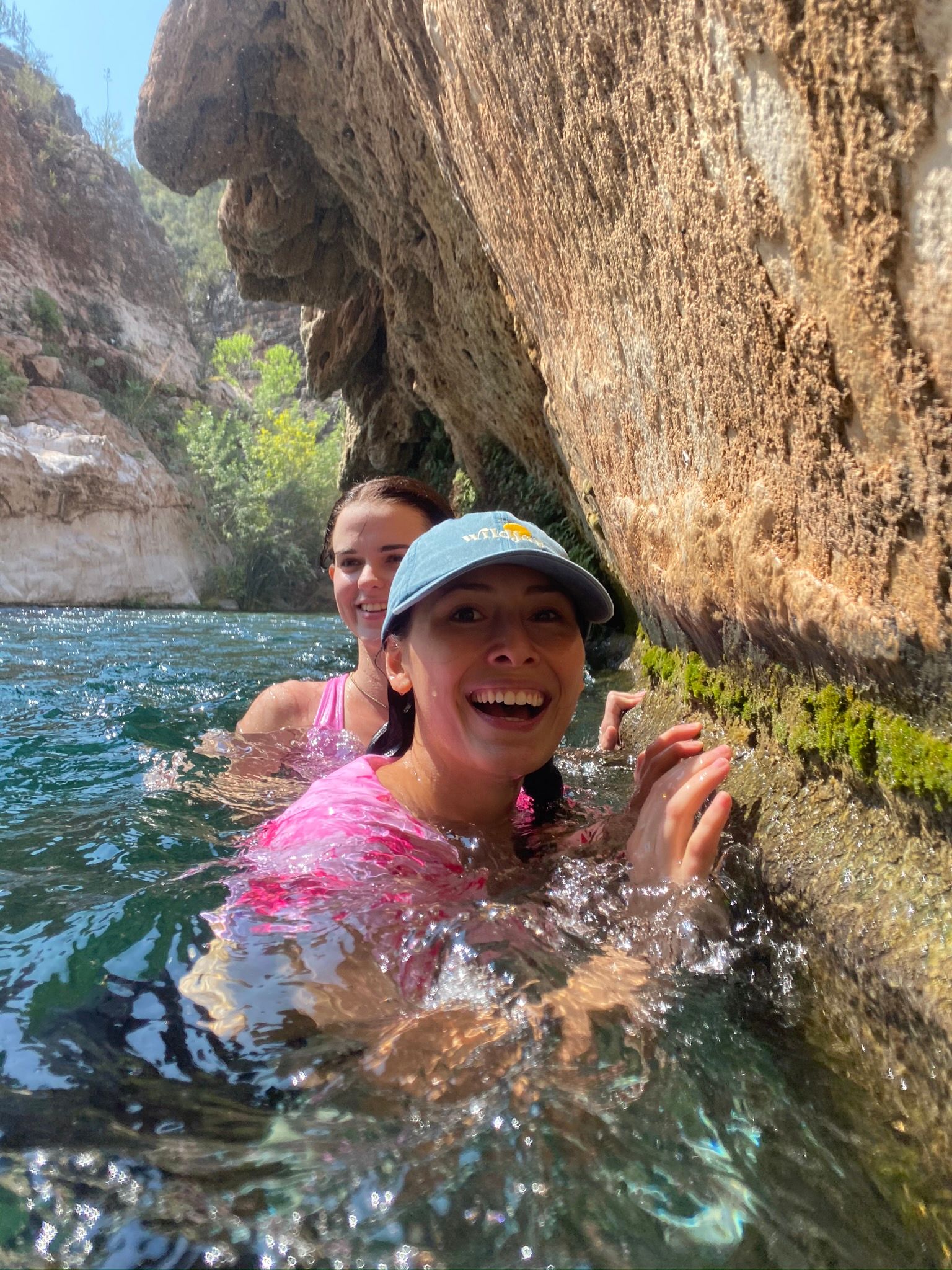 Girls swimming at Fossil Springs by the waterfall 