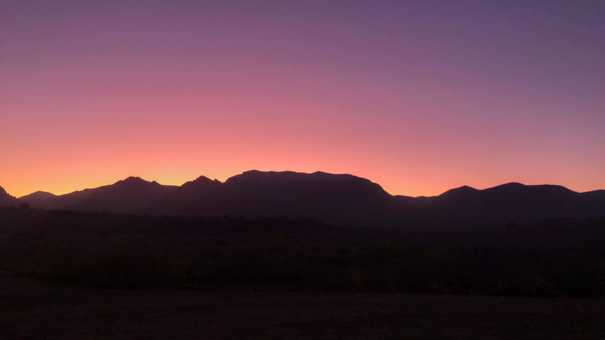 Purple, pink, yellow and orange Dirt Road Sunset in Tonto National Forest, Arizona.