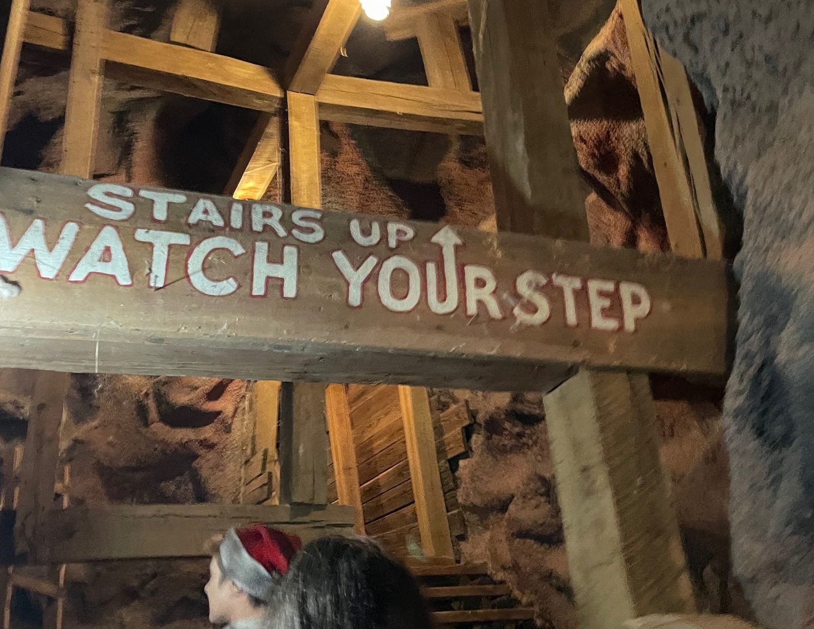 a wooden sign that says "stairs up, watch your step" at the Goldfield Ghost Town in Mesa Arizona