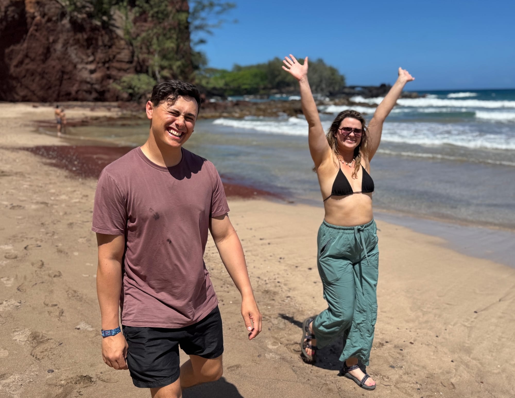 Man and Woman walking on Red Sand Beach in Maui, Hawaii