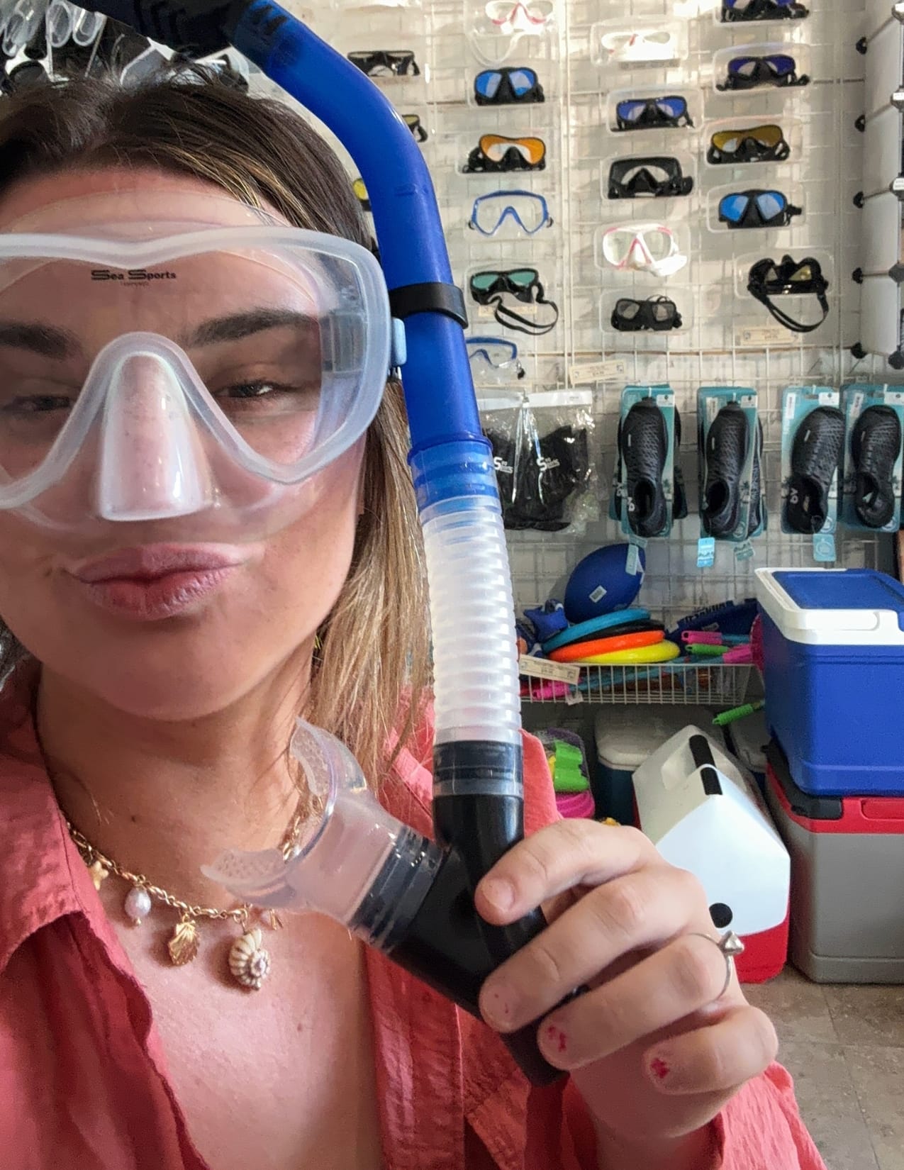 Girl in snorkeling shop wearing snorkeling gear